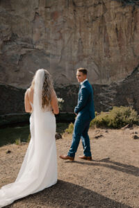 Bride and groom do their first look during golden hour at Smith Rock.