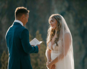 Groom reading vows to his bride at Smith Rock overlook.