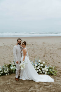Couple poses for a picture on the oregon coast at their vow renewal