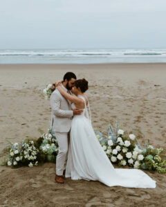 Couple exchanges a kiss on the oregon coast at their vow renewal