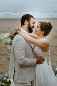 Couple exchanges a kiss on the oregon coast at their vow renewal