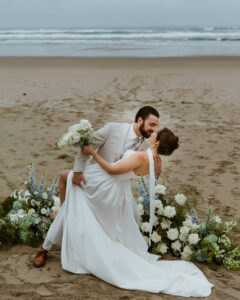 Grooms dips his bride on the oregon coast at their intimate ceremony