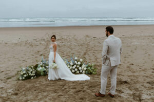 Groom admires his bride at their oregon coast vow renewal