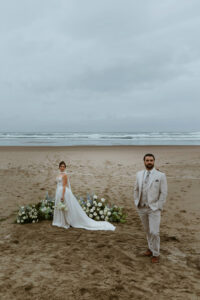 A couple poses for a picture during their oregon coast vow renewal
