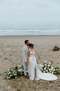 Couple looks at the ocean at their oregon coast vow renewal