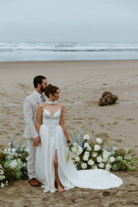 Couple looks at the ocean at their oregon coast vow renewal
