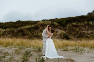 Couple takes a beach walk at their oregon coast vow renewal