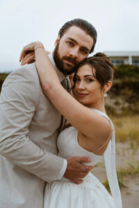 Couple poses for a picture at their oregon coast vow renewal