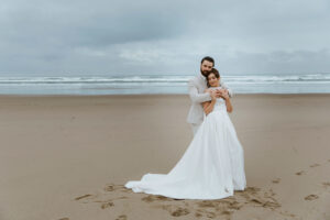 Couple poses for a picture at their oregon coast vow renewal
