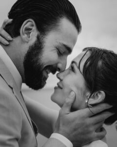 Couple exchanges a kiss in the rain at their oregon coast vow renewal
