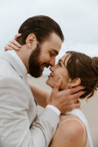 Couple exchanges a kiss in the rain at their oregon coast vow renewal