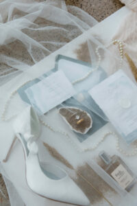 A veil overlay on the invitation suite for an oregon coast vow renewal