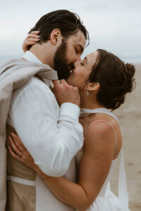 Couple exchanges a kiss at their oregon coast vow renewal