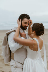 Groom looks at his bride at their oregon coast vow renewal