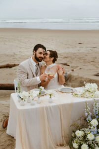 Couple shares drinks and cake at their oregon coast vow renewal