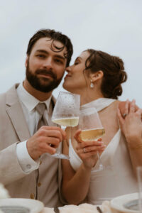 Couple shares drinks and cake at their oregon coast vow renewal
