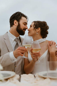 Couple shares drinks and cake at their oregon coast vow renewal
