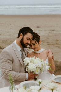 Couple shares drinks and cake at their oregon coast vow renewal