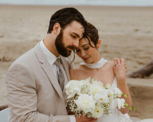 Couple admires their flowers at their oregon coast vow renewal