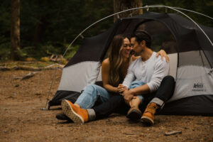 couple poses under a tent at mount rainier camping session