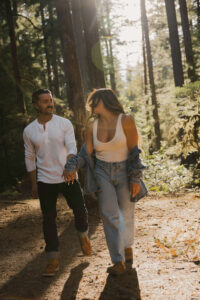 Couple walks through campground during a sunset engagement session at Mount rainier