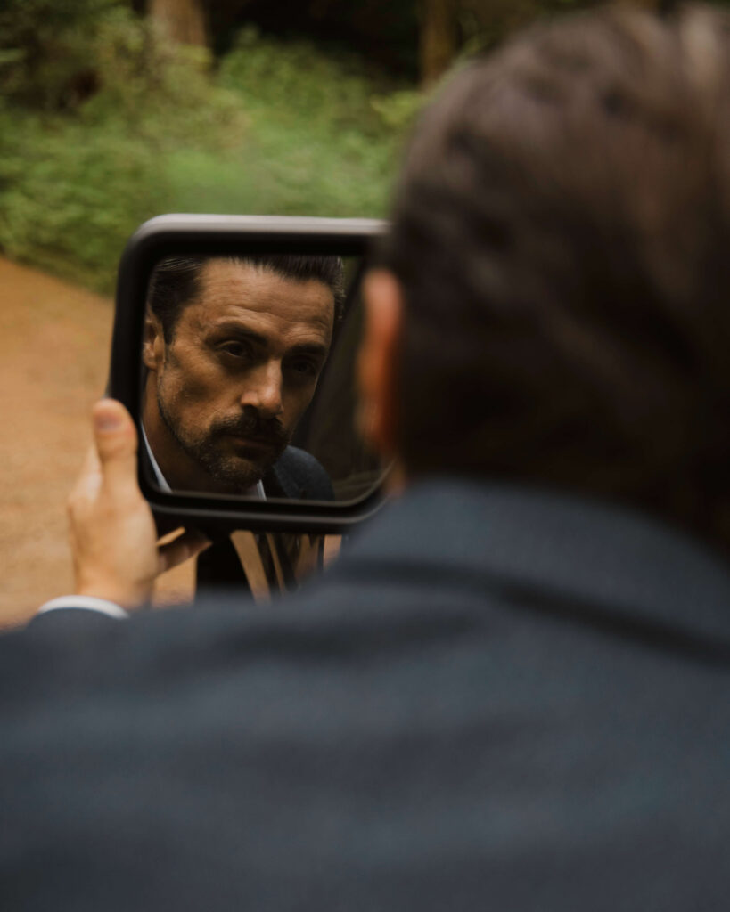 groom uses truck mirror to get ready for a mount rainier elopement