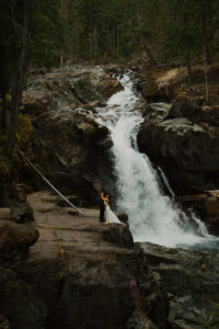 couple poses by silver falls during their mount rainier elopement