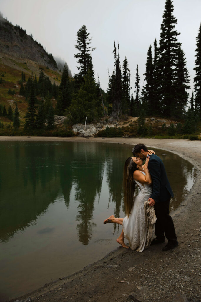 couple kisses next to an alpine lake on their mount rainier elopement hike